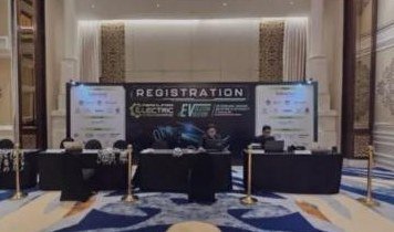 Registration counters in front of the Periklindo Electric Vehicle Conference backdrop